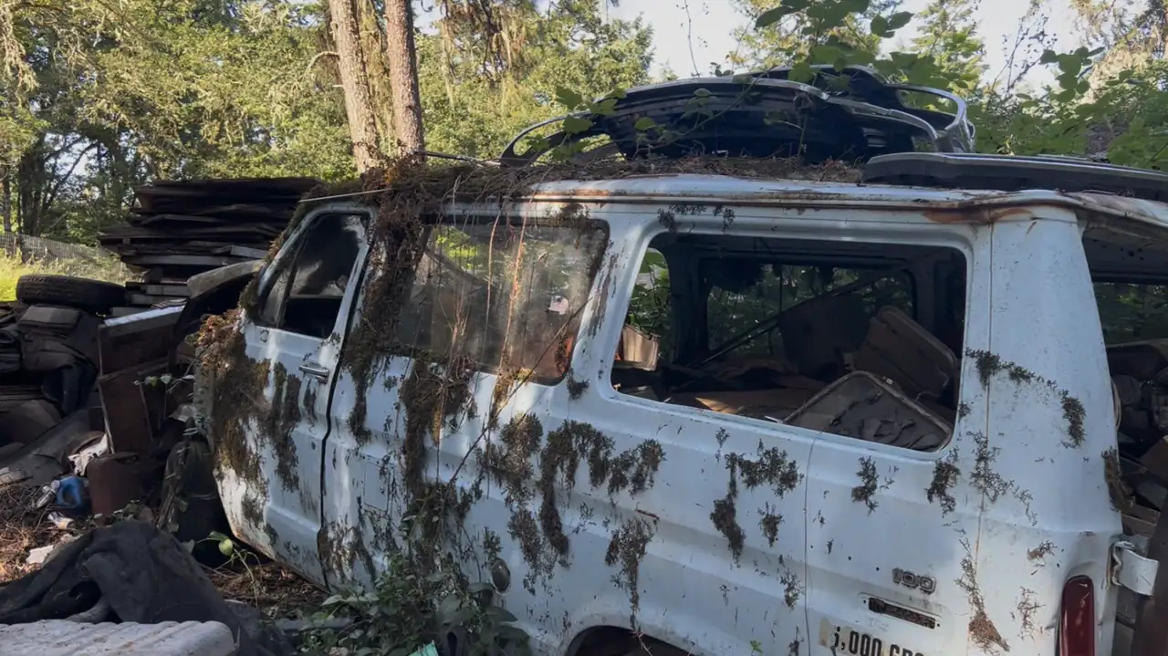 Junk car staged for removal in a Eugene backyard