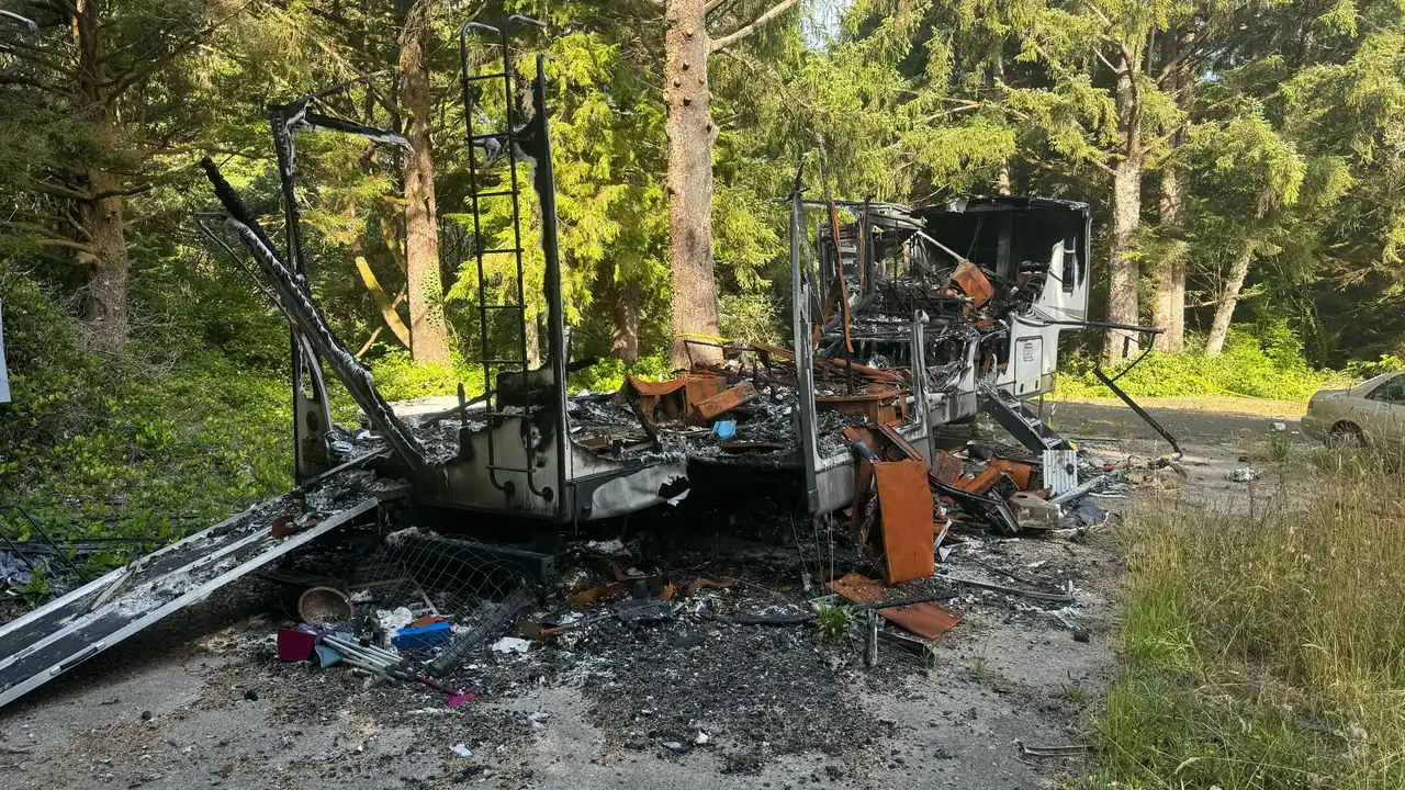 RV staged for removal in a wooded coastal property
